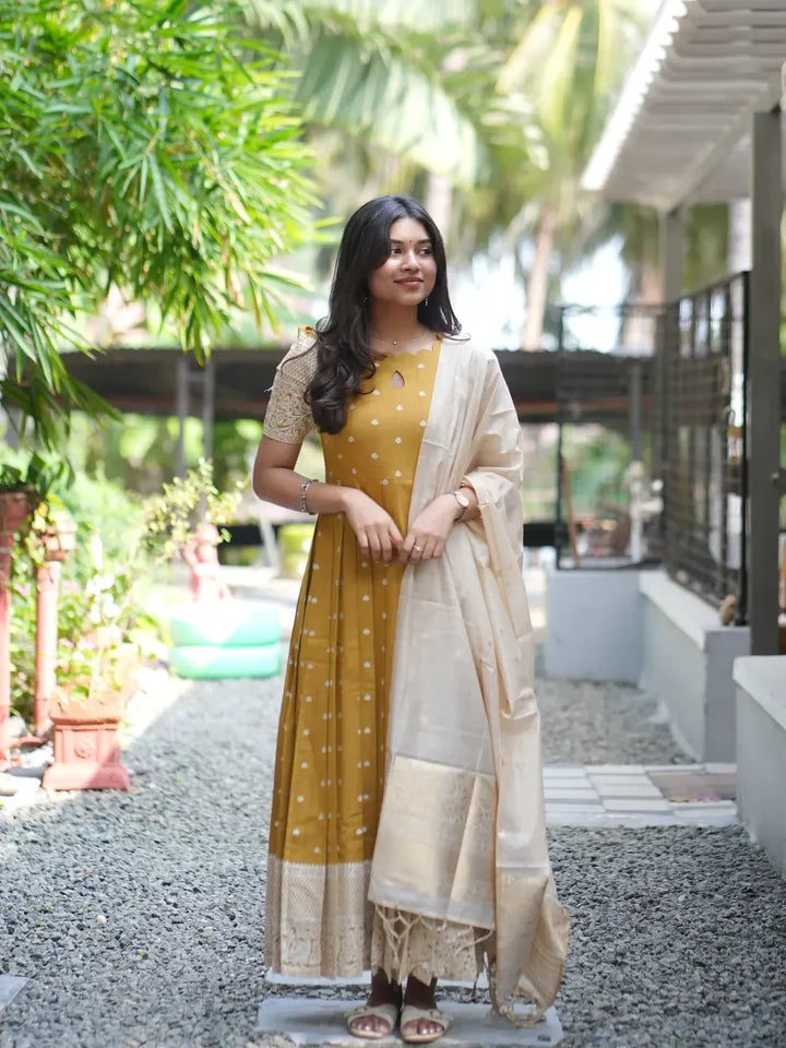 Mustard ethnic with a ivory soft zari weaved dupatta